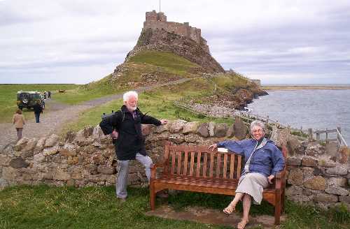 Visitors relax after exploring the iconic Lindisfarne Castle.