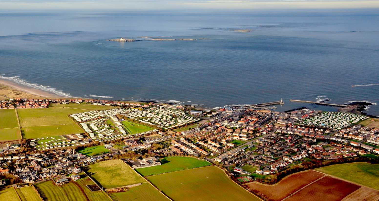 Aerial view of seahouses and the Farne Islands.